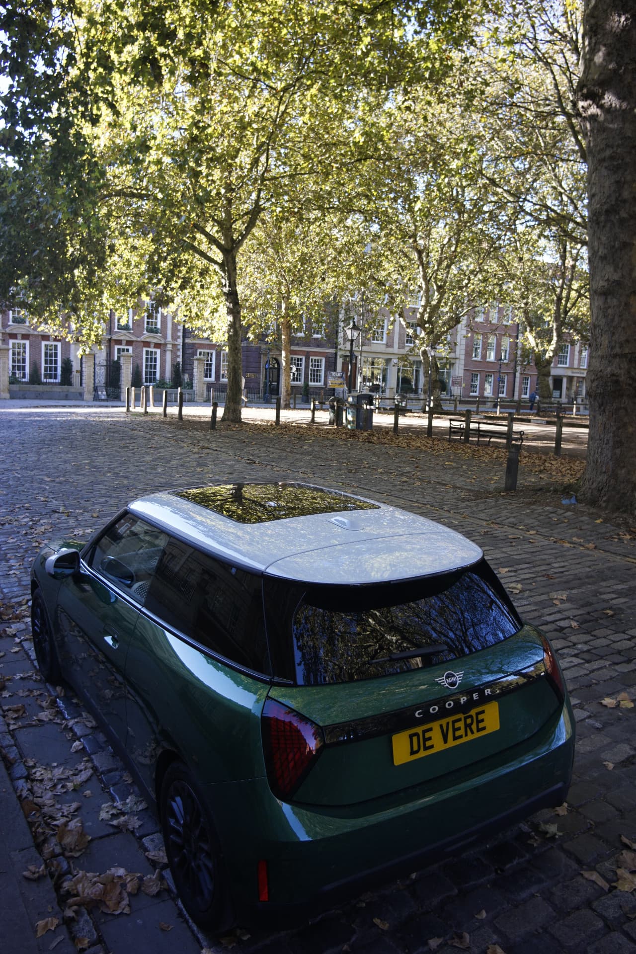 Panoramic glass roof in the white roof of the green MINI Cooper E